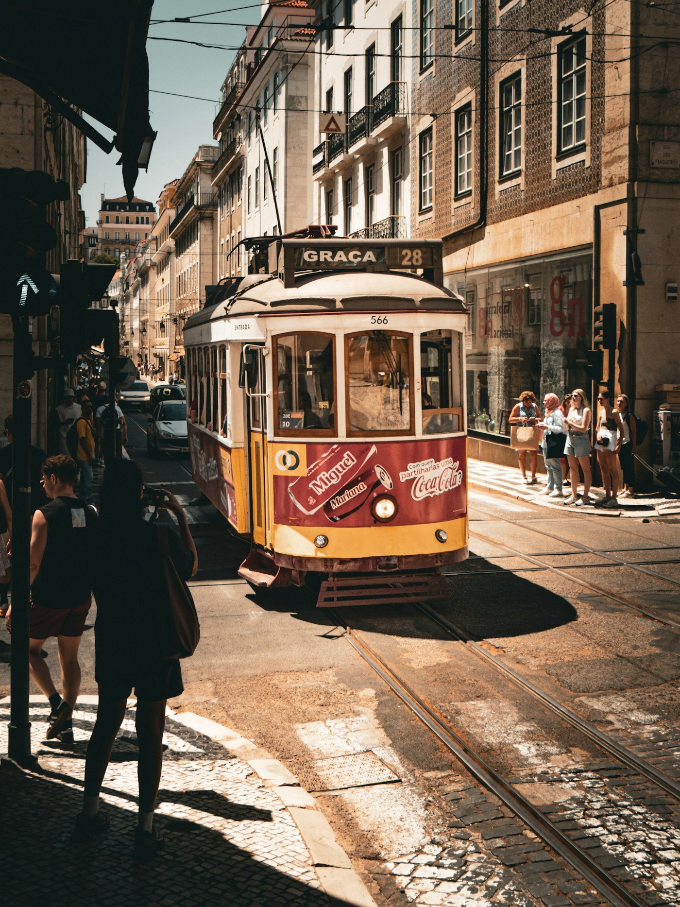 Yellow vintage tram on a sunny Lisbon street